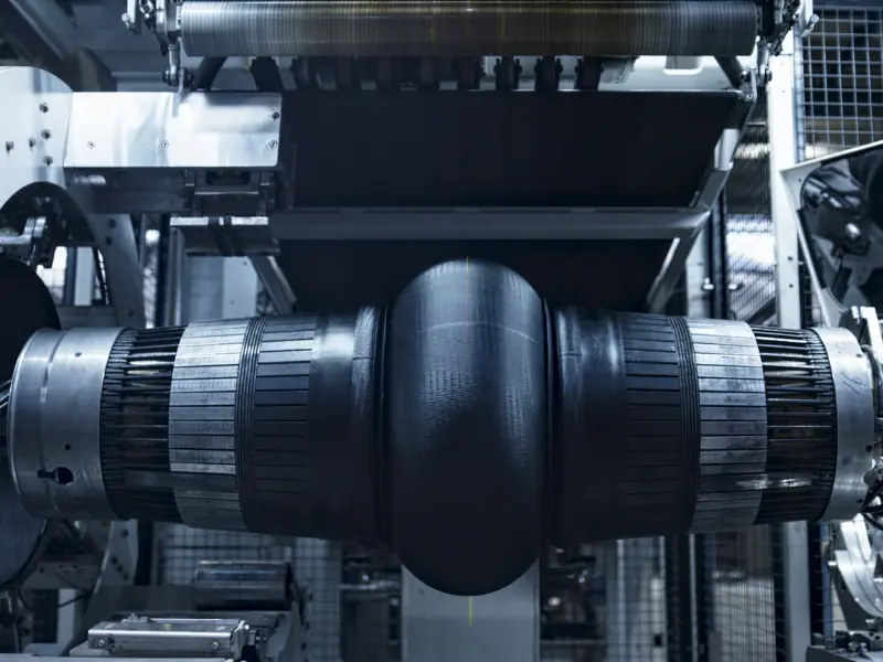 Équipement de fabrication de pneus dans un environnement industriel.