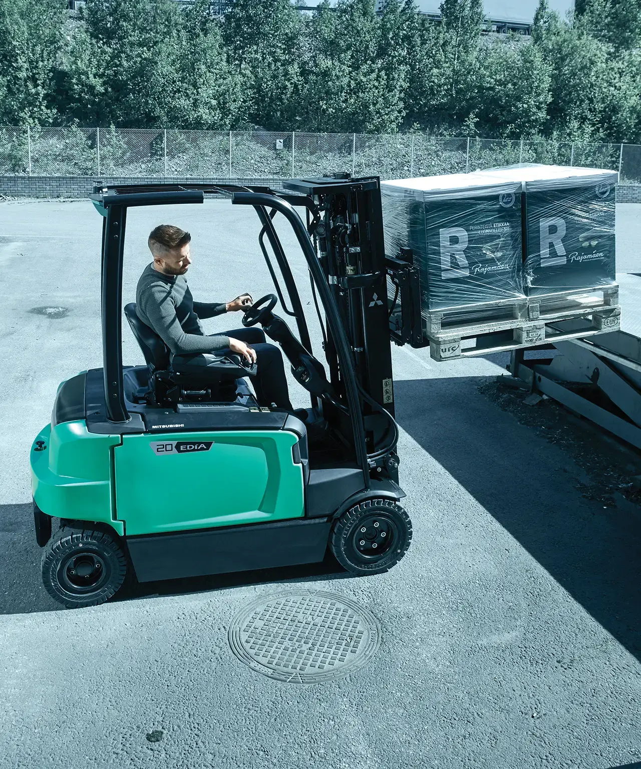 chariot élévateur frontal chargeant un camion en extérieur